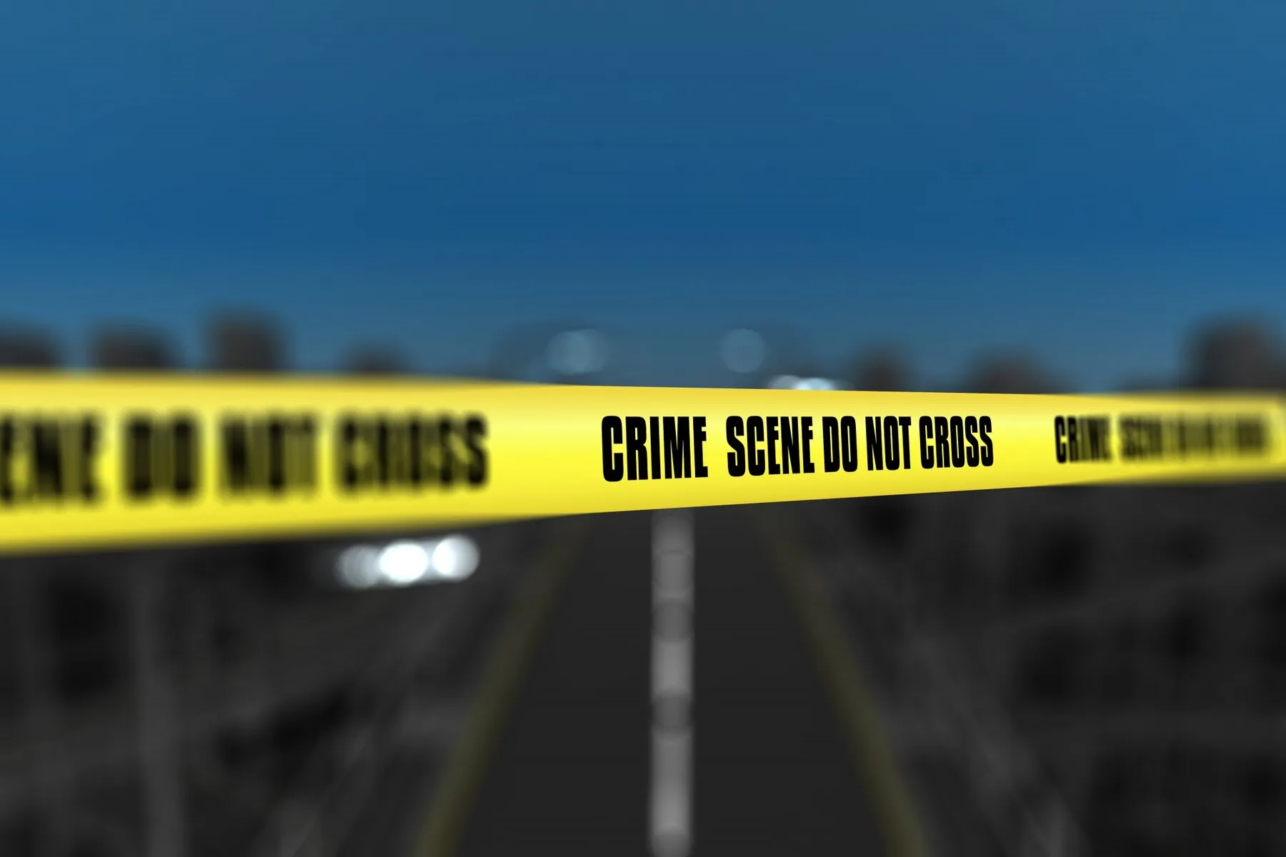 Crime scene tap in front of highway.