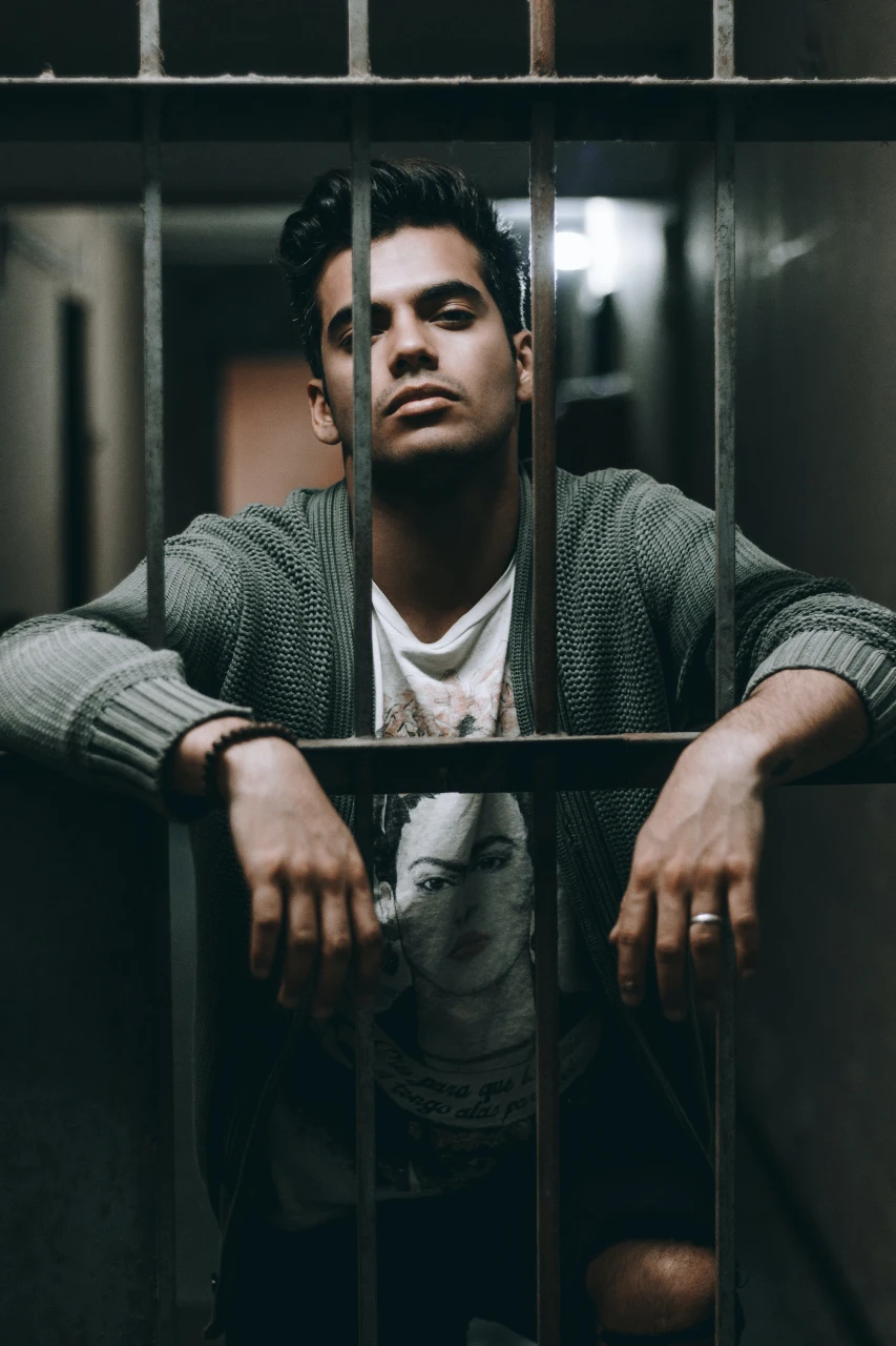 Man in a jail cell.
